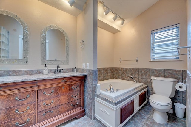 bathroom featuring lofted ceiling, tile walls, a bathtub, vanity, and toilet