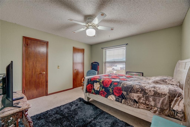 bedroom featuring carpet flooring, a textured ceiling, and ceiling fan