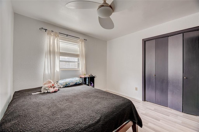 bedroom featuring light hardwood / wood-style floors, a closet, and ceiling fan