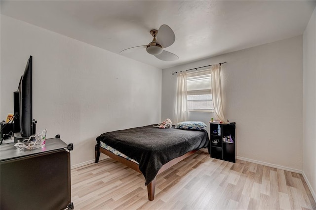 bedroom with ceiling fan and light hardwood / wood-style flooring