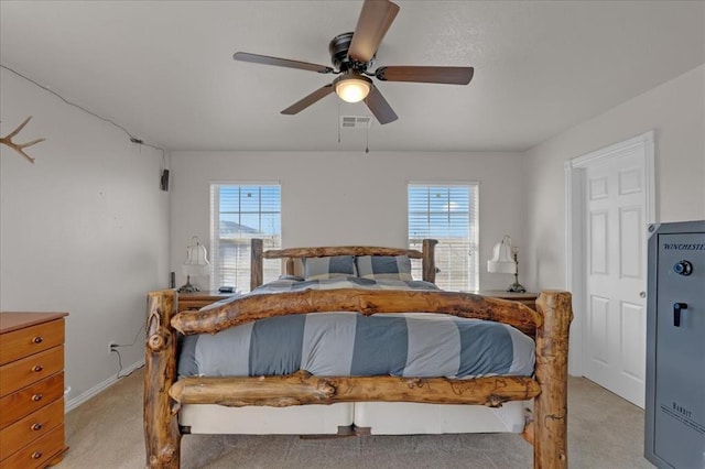 bedroom featuring multiple windows, visible vents, a ceiling fan, and light colored carpet