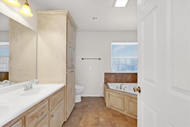 full bath featuring double vanity, visible vents, toilet, a bath, and a sink