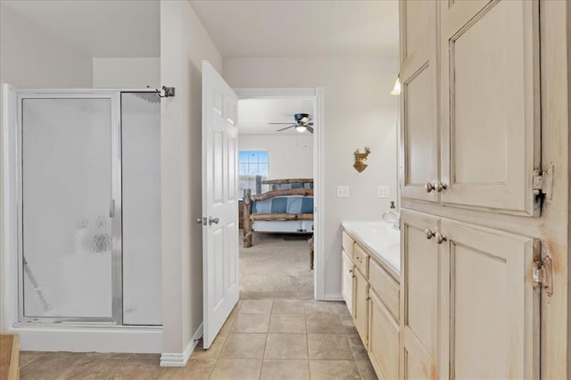 bathroom featuring a ceiling fan, a shower stall, ensuite bath, vanity, and tile patterned floors