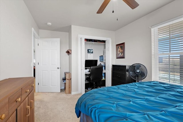 bedroom featuring a closet, light carpet, and ceiling fan