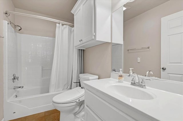 bathroom with toilet, tile patterned flooring, shower / bath combo with shower curtain, and vanity