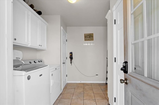 laundry room featuring cabinet space, washer and clothes dryer, baseboards, and light tile patterned floors