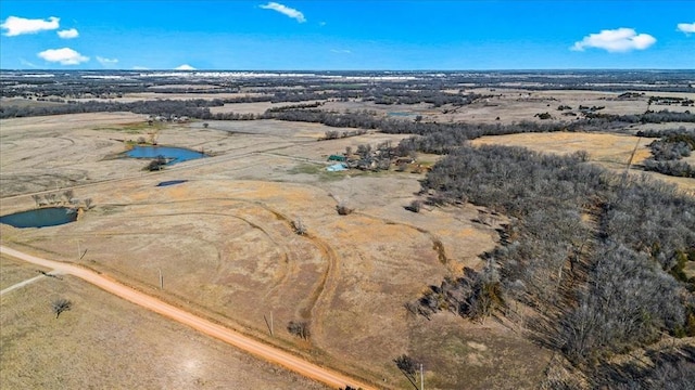 drone / aerial view featuring a water view and a rural view