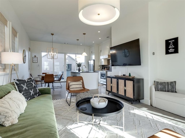 living room with sink and a notable chandelier