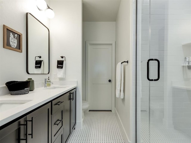 bathroom with vanity, toilet, and a shower with door