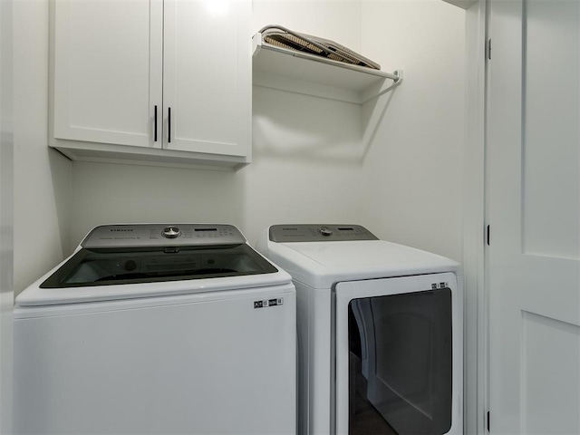 laundry area with cabinets and washing machine and dryer