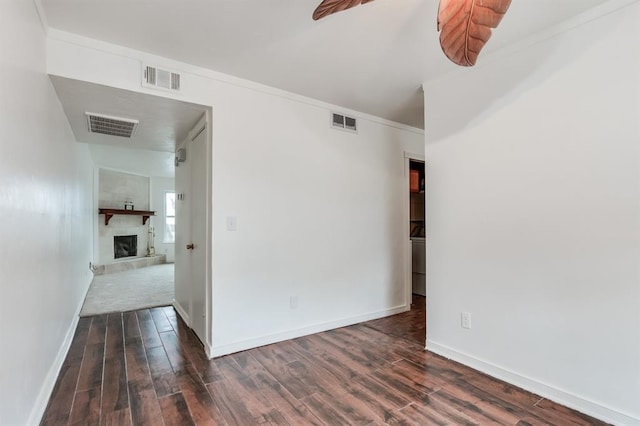 spare room with dark wood-type flooring and ornamental molding