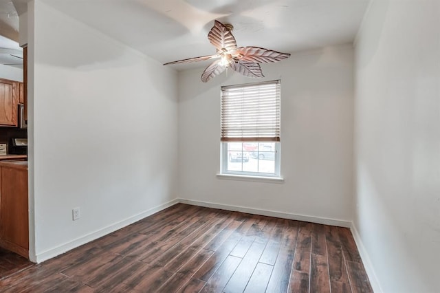 empty room featuring ceiling fan and dark hardwood / wood-style floors