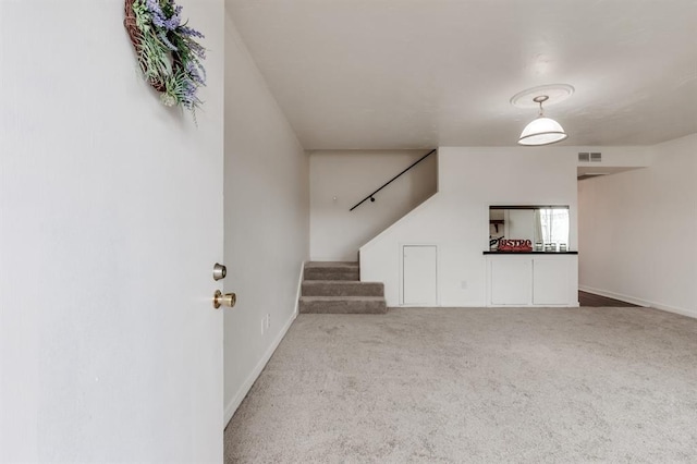 unfurnished living room featuring carpet