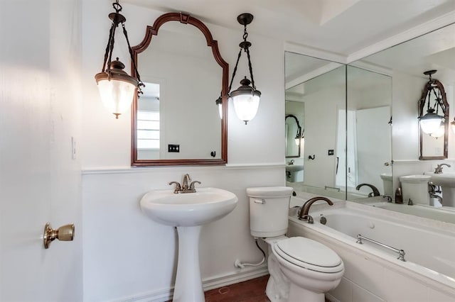 bathroom featuring sink, toilet, and a bathing tub