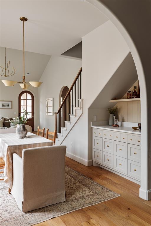 dining space featuring vaulted ceiling and light wood-type flooring