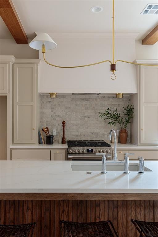 kitchen featuring decorative light fixtures, a kitchen breakfast bar, high end stainless steel range oven, beam ceiling, and backsplash