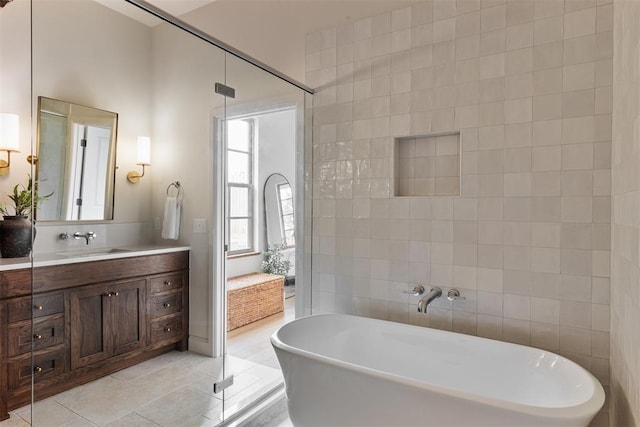 bathroom featuring tile walls, vanity, tile patterned floors, and separate shower and tub