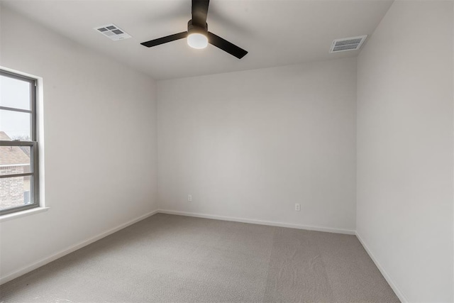 carpeted empty room featuring ceiling fan