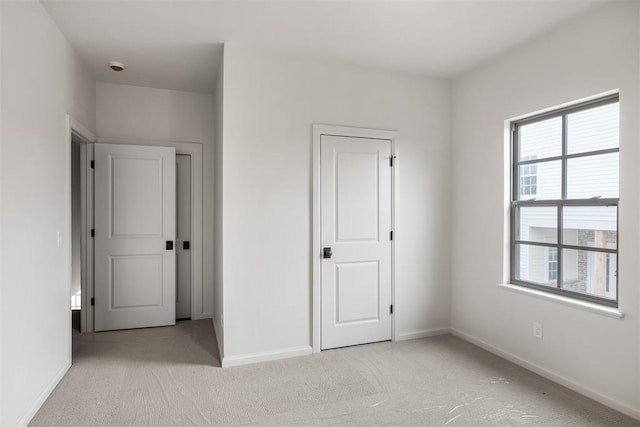 unfurnished bedroom featuring light colored carpet