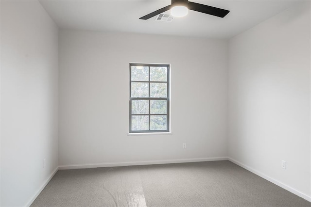 spare room featuring ceiling fan and carpet flooring