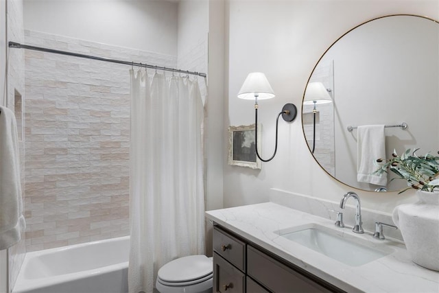 full bathroom with vanity, toilet, and shower / bath combo with shower curtain