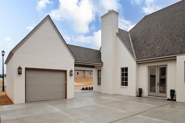 exterior space with french doors and a garage