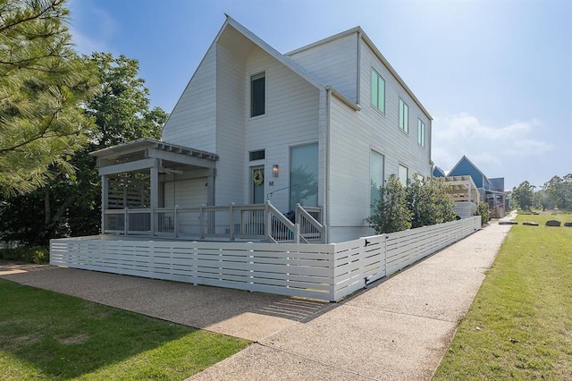 contemporary home featuring covered porch and a front lawn