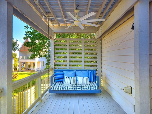 wooden terrace featuring a ceiling fan