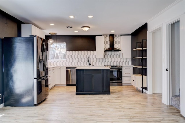 kitchen featuring stainless steel appliances, visible vents, white cabinetry, light countertops, and wall chimney exhaust hood