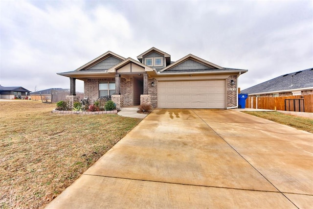 craftsman-style home featuring a garage and a front lawn