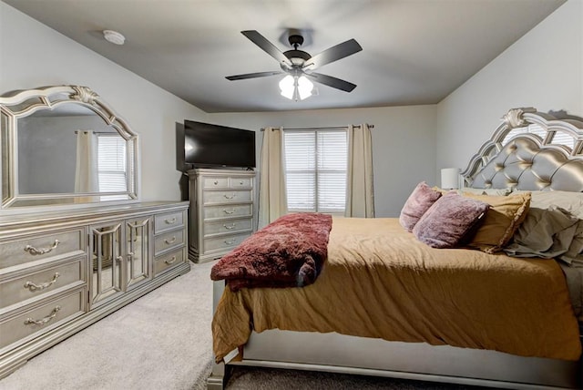 carpeted bedroom featuring multiple windows and ceiling fan