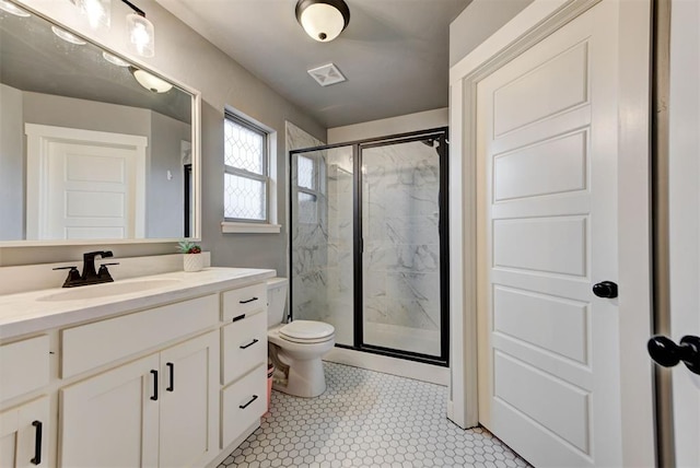 bathroom with vanity, toilet, and an enclosed shower