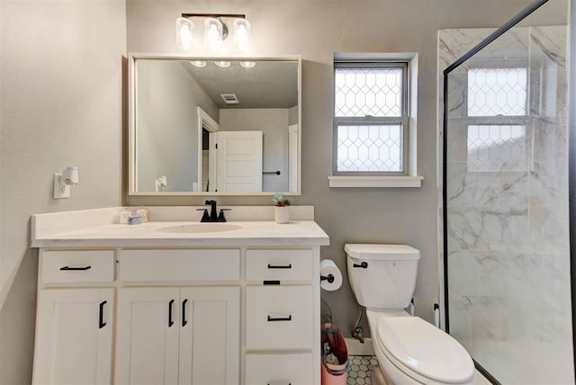 bathroom with walk in shower, vanity, and toilet