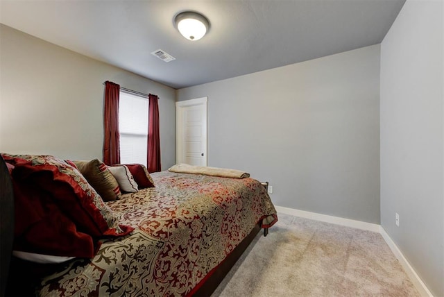 bedroom featuring light carpet