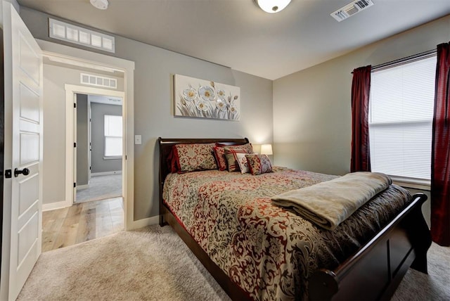 bedroom with light colored carpet