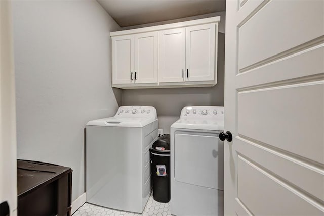 washroom with washer and clothes dryer and cabinets