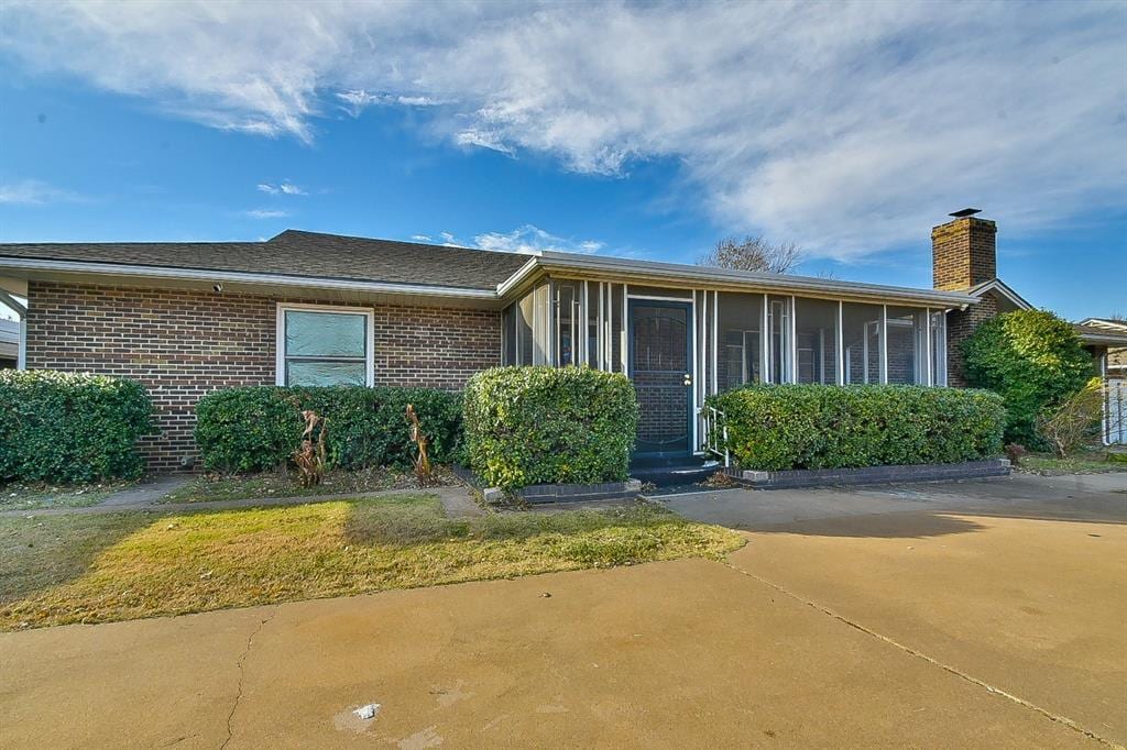 view of front of house with a sunroom