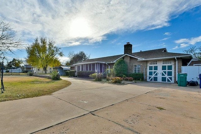 view of front of house featuring a garage and a front lawn