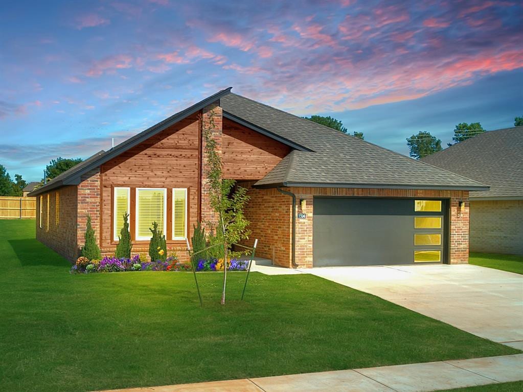 modern home with a garage and a lawn