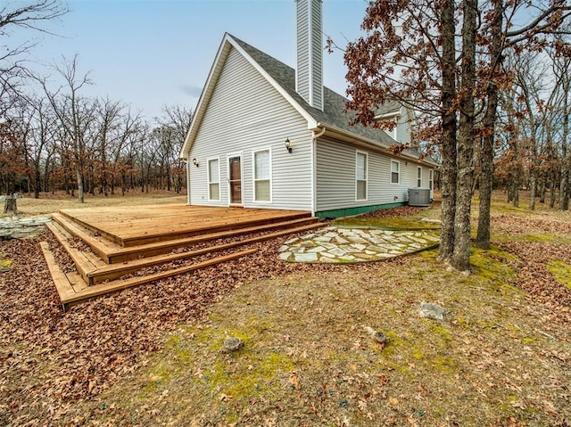 view of home's exterior with cooling unit and a wooden deck