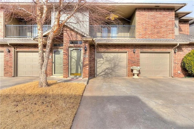 townhome / multi-family property featuring a garage and a balcony