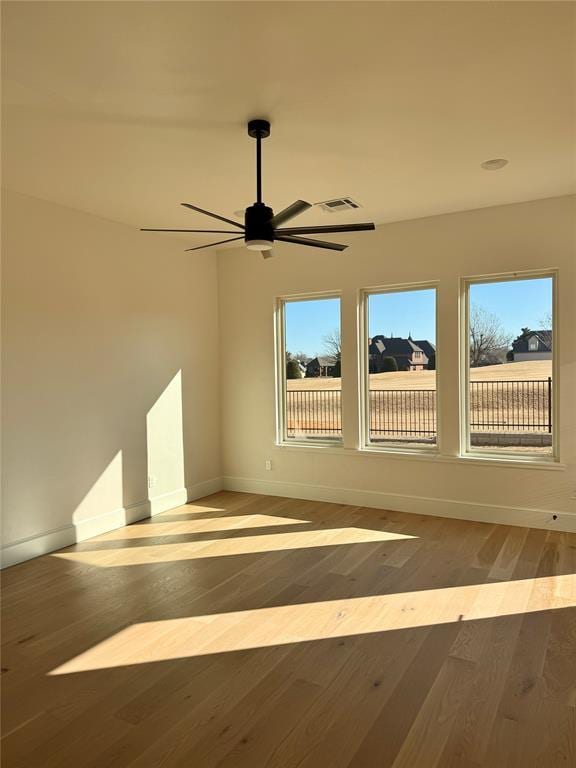 spare room featuring hardwood / wood-style floors and ceiling fan