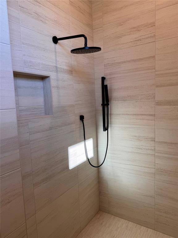 bathroom with tiled shower