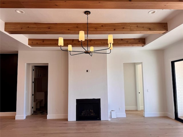 unfurnished living room with a fireplace, beamed ceiling, light wood finished floors, and baseboards