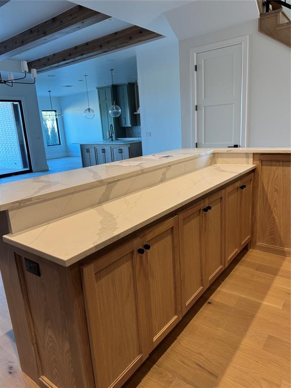 bathroom with beamed ceiling and wood finished floors