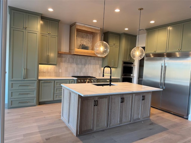 kitchen with light stone counters, pendant lighting, stainless steel appliances, open shelves, and a sink