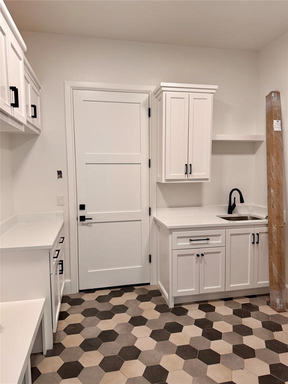 interior space with dark floors and a sink