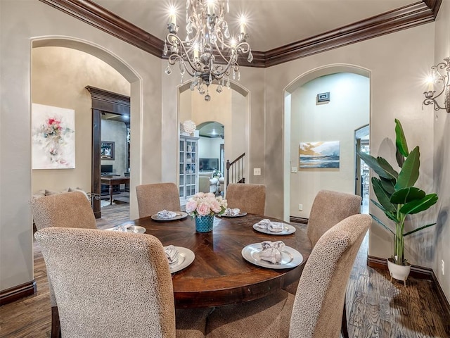 dining space featuring crown molding, dark hardwood / wood-style floors, and a chandelier