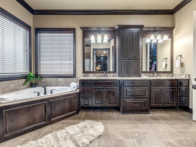 bathroom featuring ornamental molding, vanity, and a tub