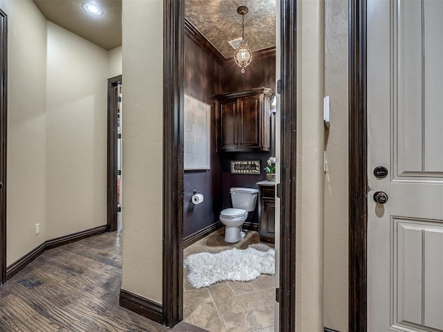 bathroom with hardwood / wood-style flooring and toilet